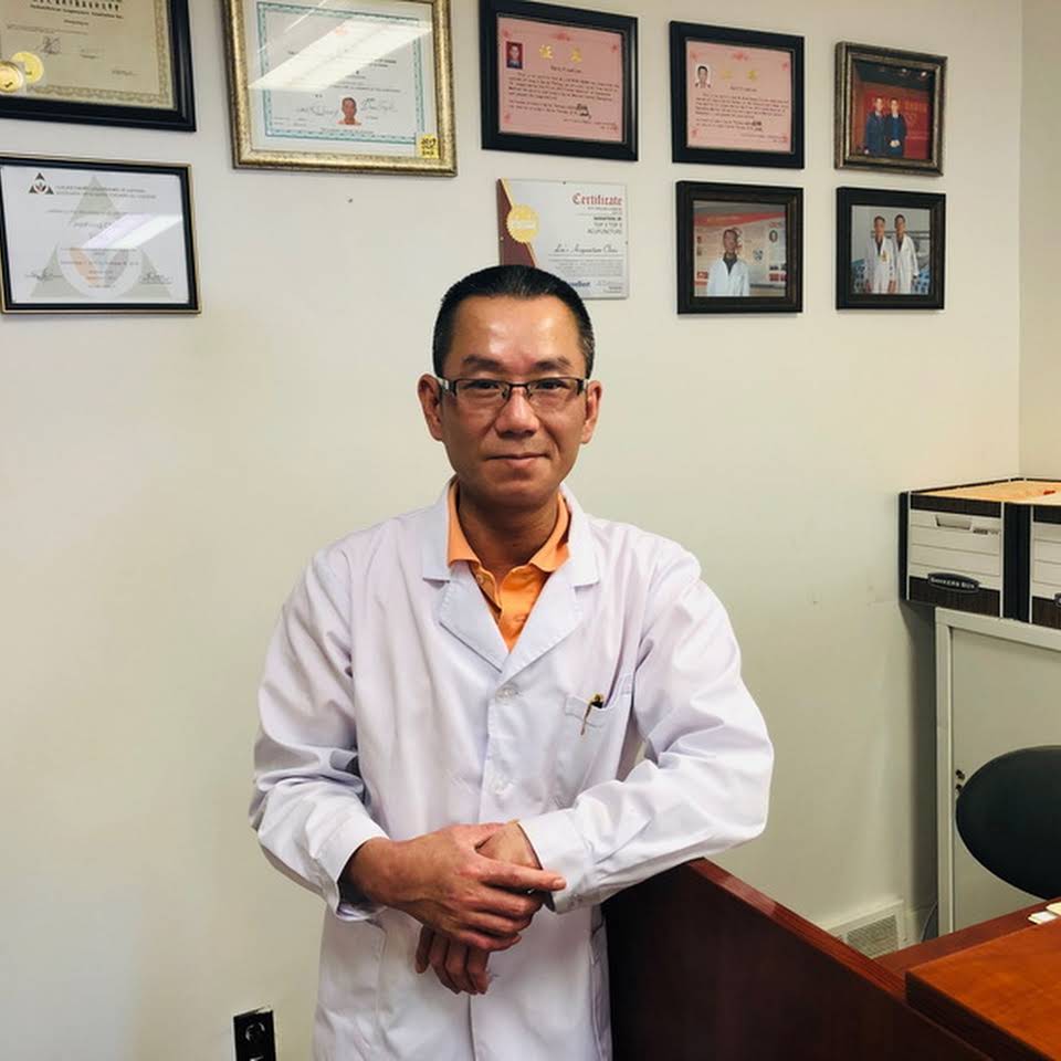 Dr. Miaoguang Lin standing in the clinic